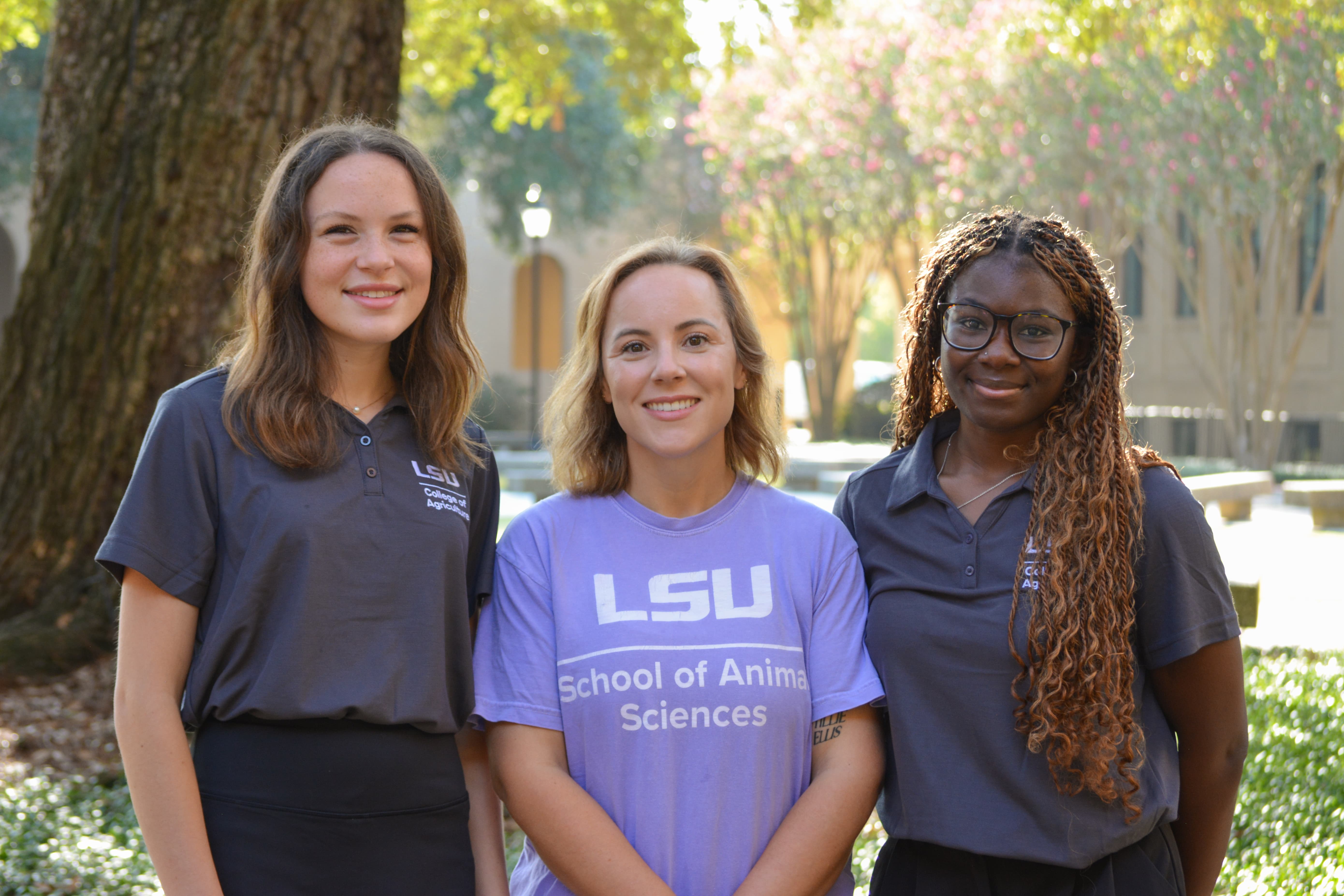 Peer Mentor Leader stands with peer mentors Z'rai Johnson and Olivia Cate