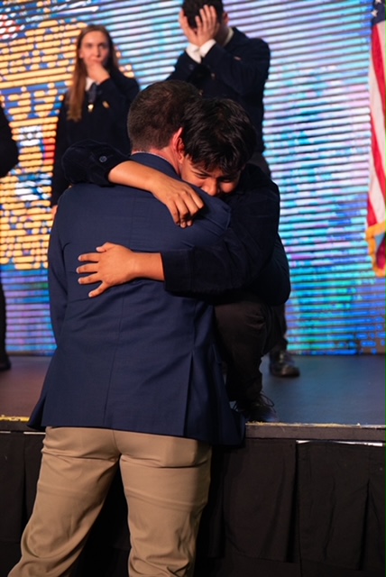 Nick hugging a student