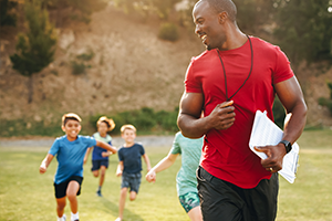 coach or teacher running with students