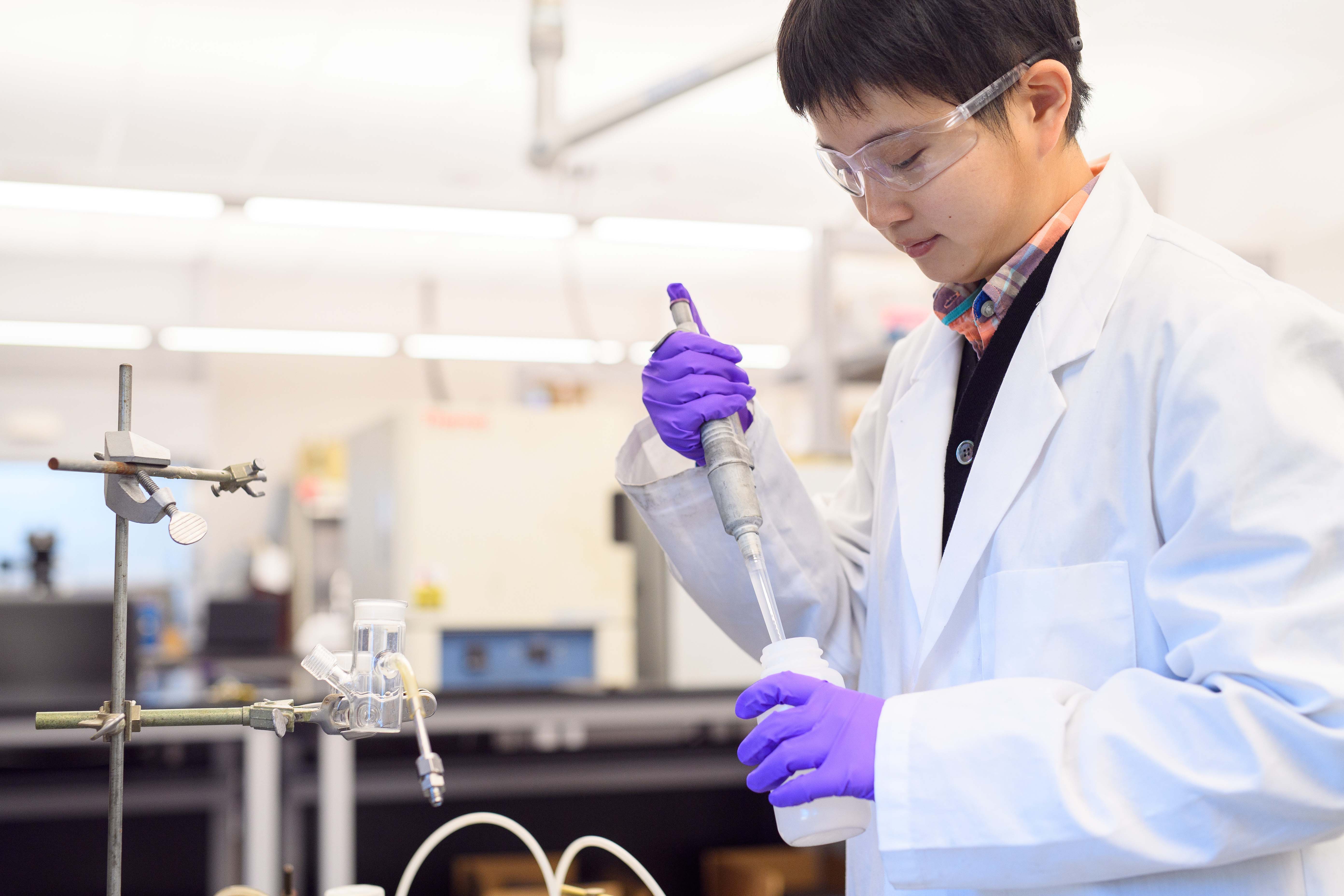 Yuxin Fang holding beaker