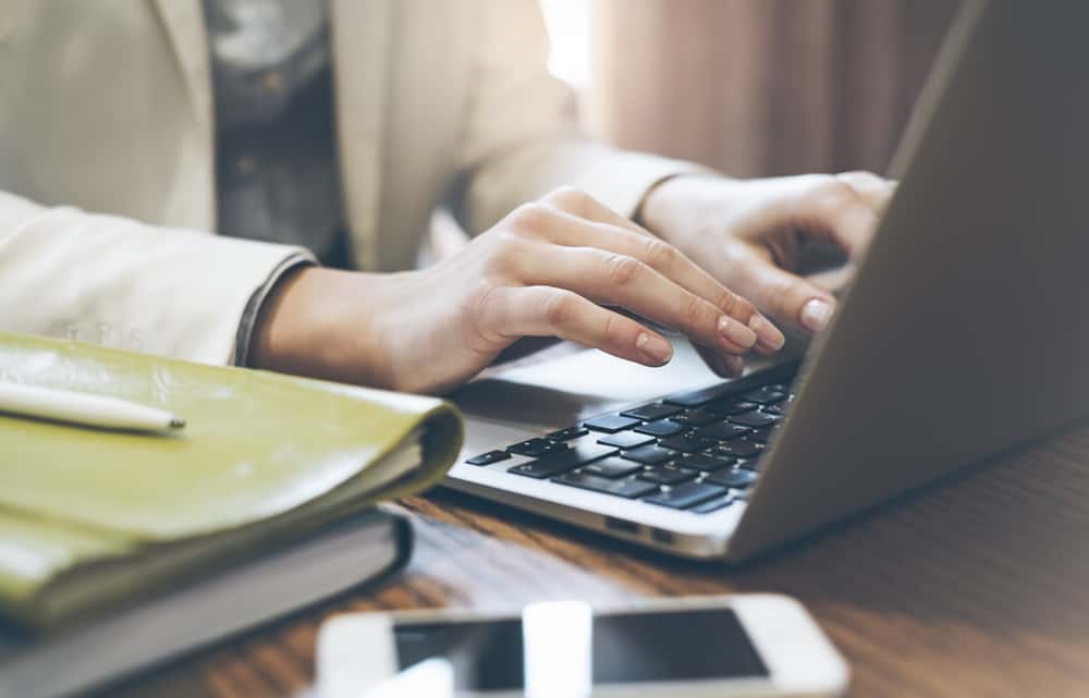 woman writing at computer