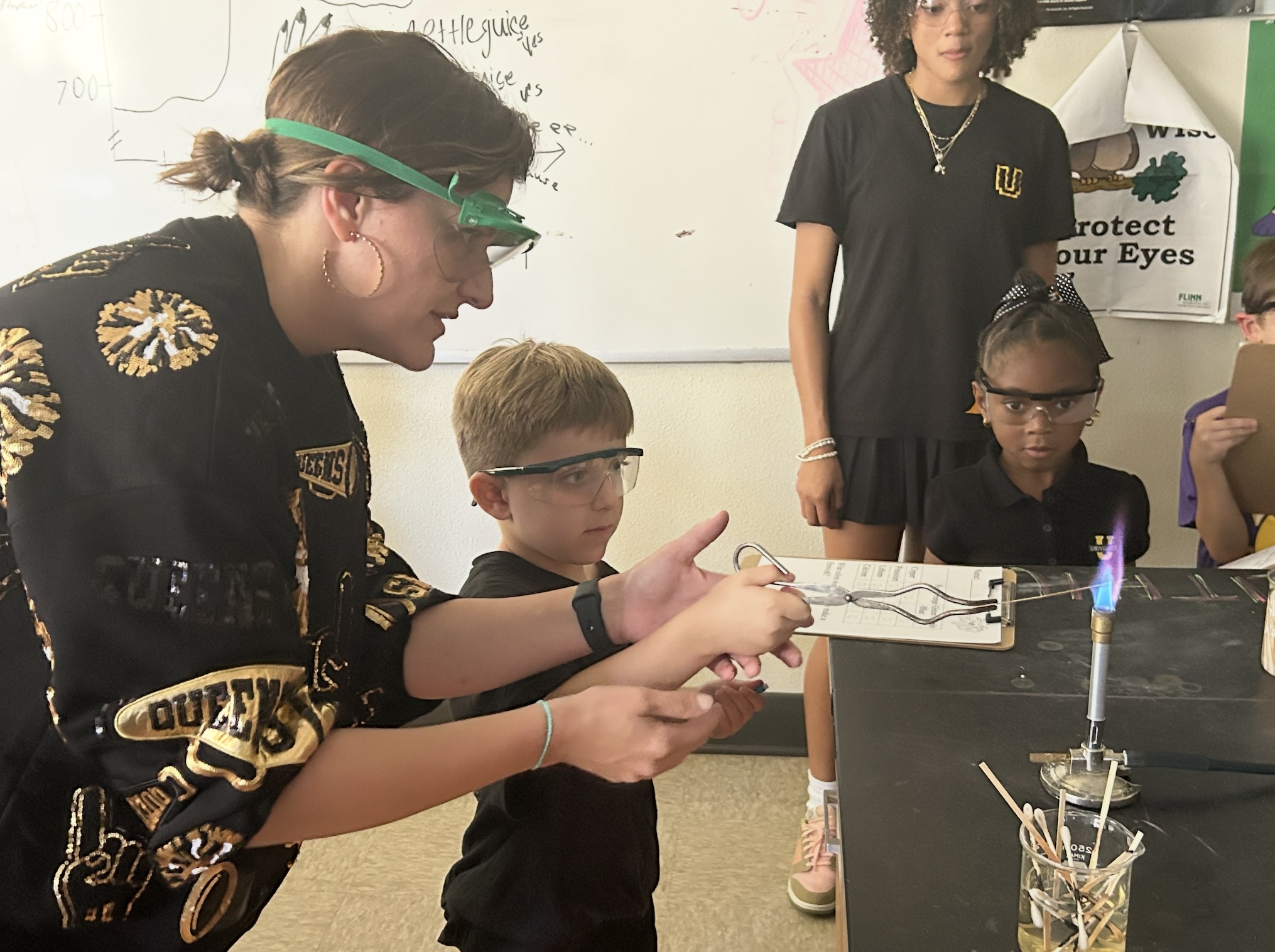 Teacher doing flame test in chemistry lab